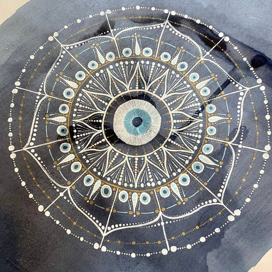 Mandala with an evil eye at it's centre, drawn in white and pale blue gel pens on a background of dark blue elderberry ink