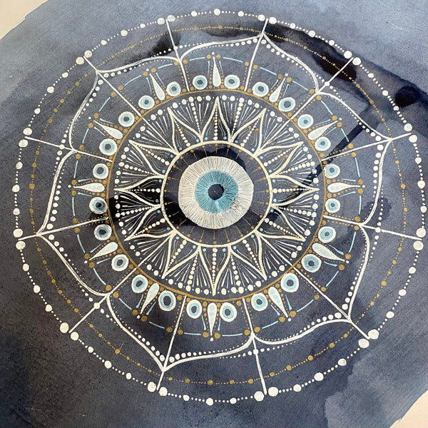 Mandala with an evil eye at its centre in elderberry ink